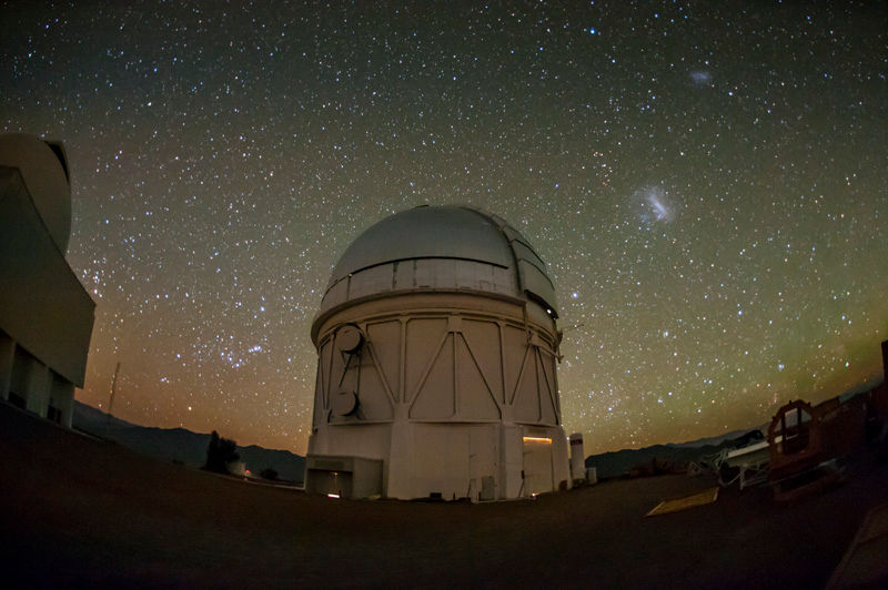A nighttime image of an observatory under a starry sky.