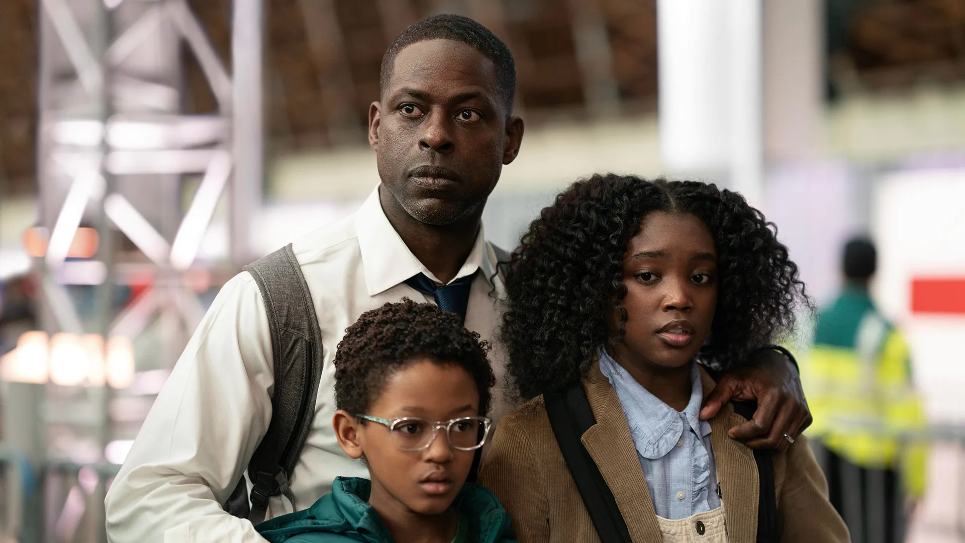 Xavier (Sterling K. Brown) wraps his arms around his children, Presley (Aliyah Mastin) and James (Percy Daggs IV)