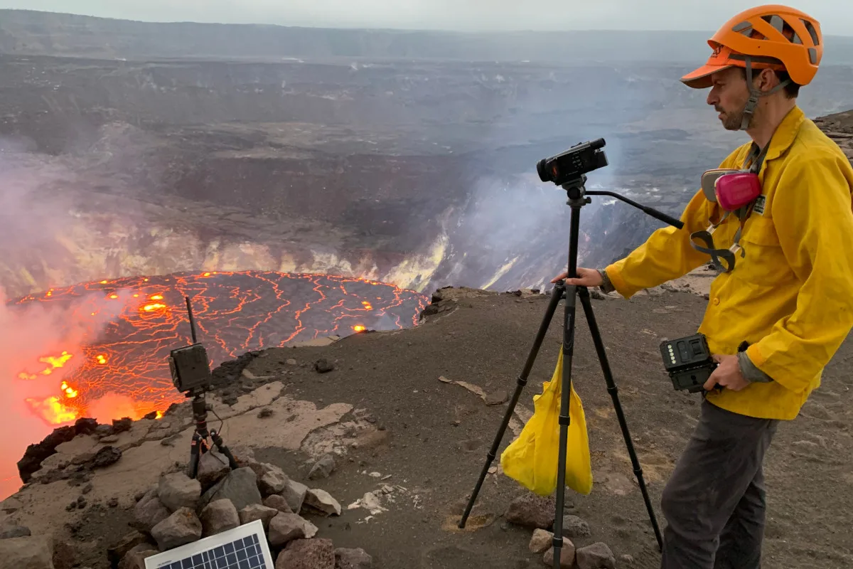 A geologist takes a video of an eruption from the Halema’uma’u crater in Hawaii in 2021