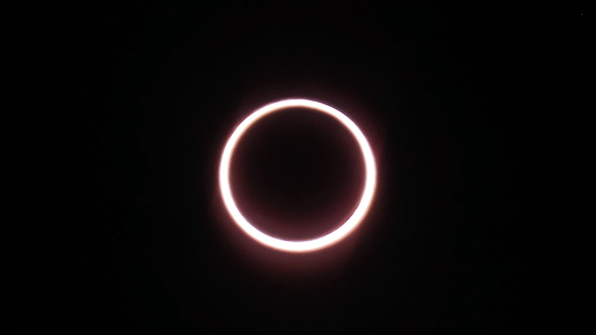 a glowing ring of light against a black background as the annular solar eclipse reaches peak annularity from Antarctica.