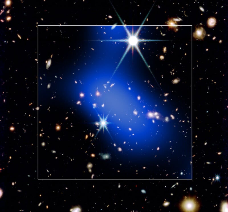 A galaxy cluster in deep space, filled with scattered stars, faint galaxies, and a highlighted blue region within a white square, representing a concentration of dark matter.