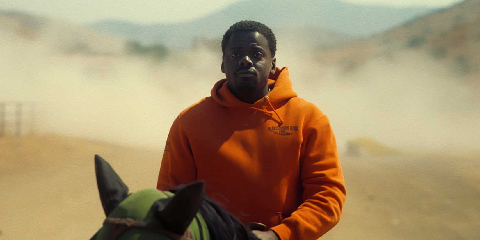 Daniel Kaluuya riding a horse in the desert in Nope