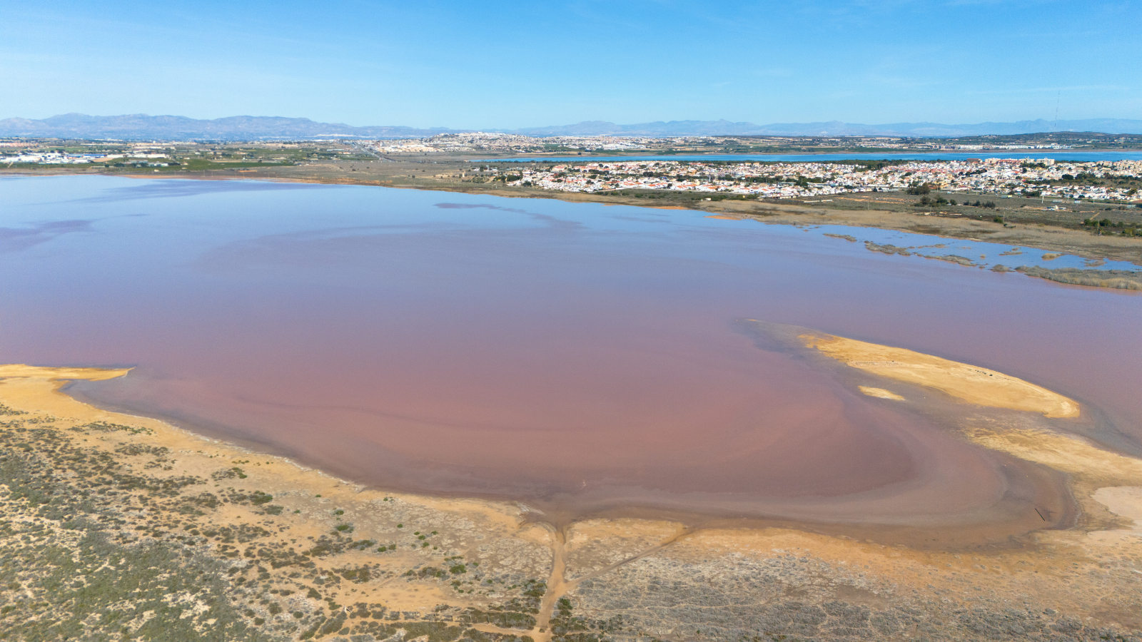 A photo of a pink salt lake in Spain