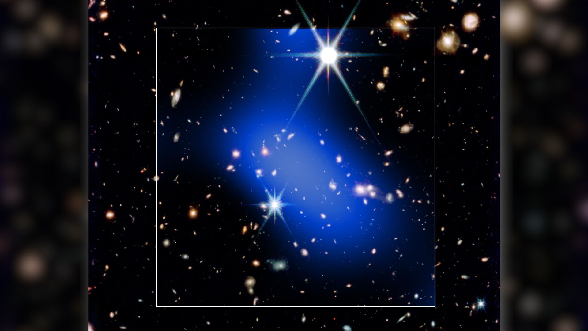 A bright blue streak of light is seen covering a series of bright stars in this dark deep space image. A white box surrounds the blue shape