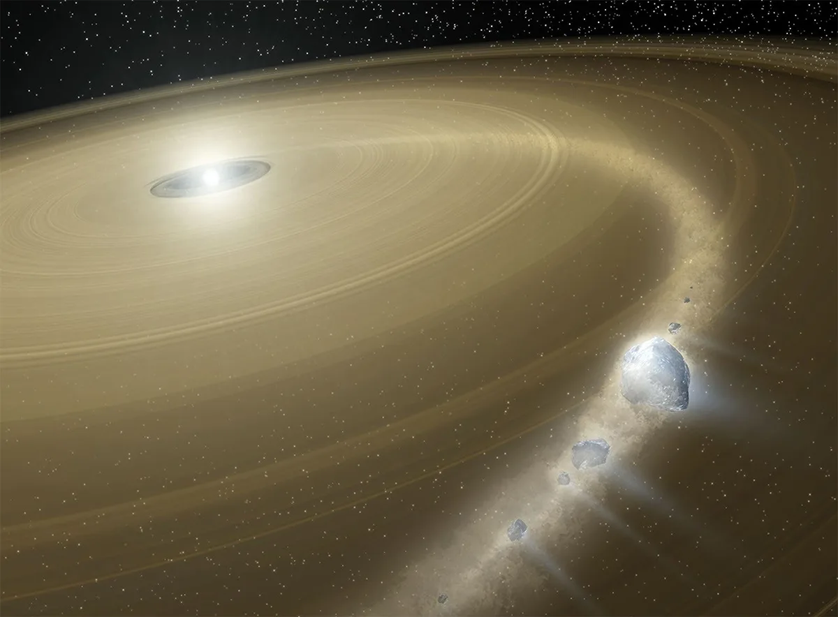 Illustration showing a white dwarf surrounded by a large debris disk. Debris from a Pluto-like object is falling onto the white dwarf. Credit: Artwork: NASA, Tim Pyle (NASA/JPL-Caltech)