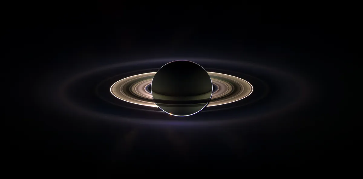 15th September 2006. Saturn sheltering Cassini from the blinding glare of the Sun, brightening microscopic particles and revealing previously unknown faint rings. (Credit: NASA/JPL/Space Science Institute)