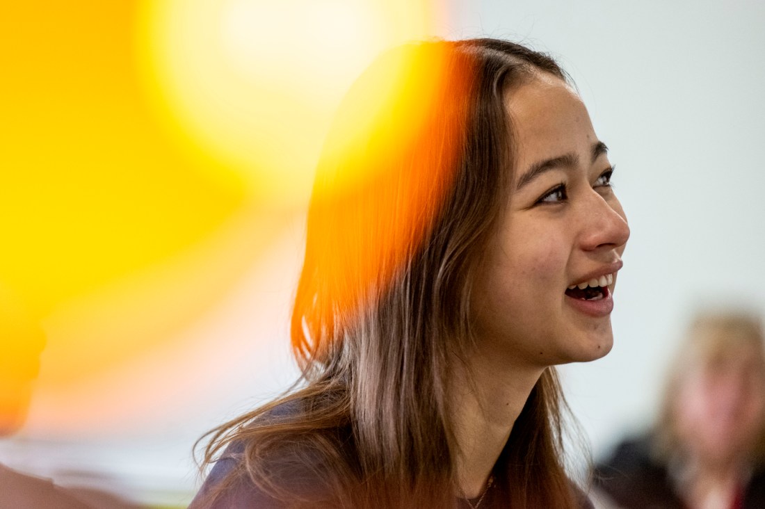 A student listens attentively during a classroom presentation.