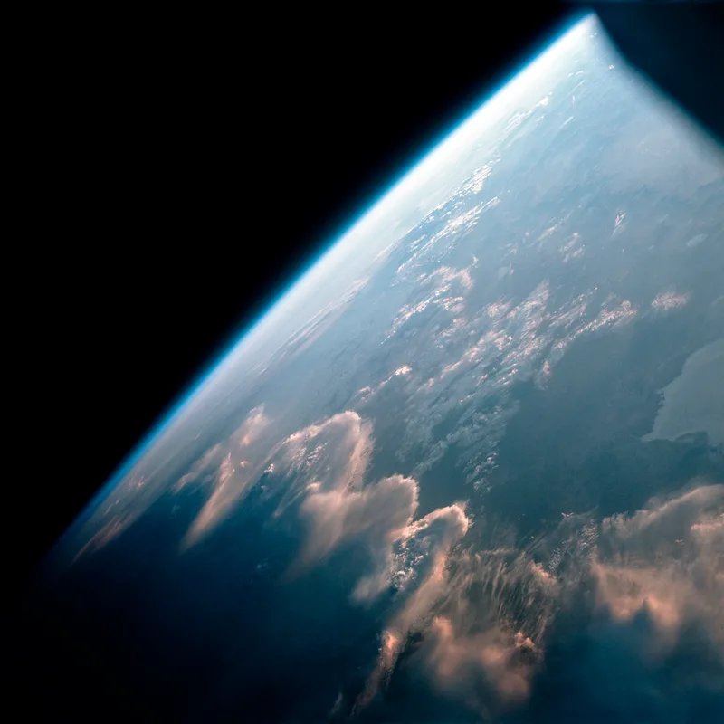 Wave clouds illuminated by the low Sun like a golden fire as Gemini 7 passes over Earth's terminator (day to night) on 12th December, 1965. Credit NASA / ASU / Andy Saunders