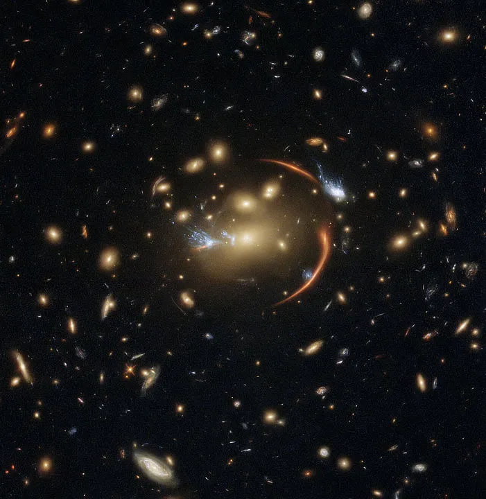Gravitational lensing caused by foreground galaxy cluster MACSJ0138.0-2155 brings far-distant galaxy MRG-M0138 into view. Credit: ESA/Hubble & NASA, A. Newman, M. Akhshik, K. Whitaker