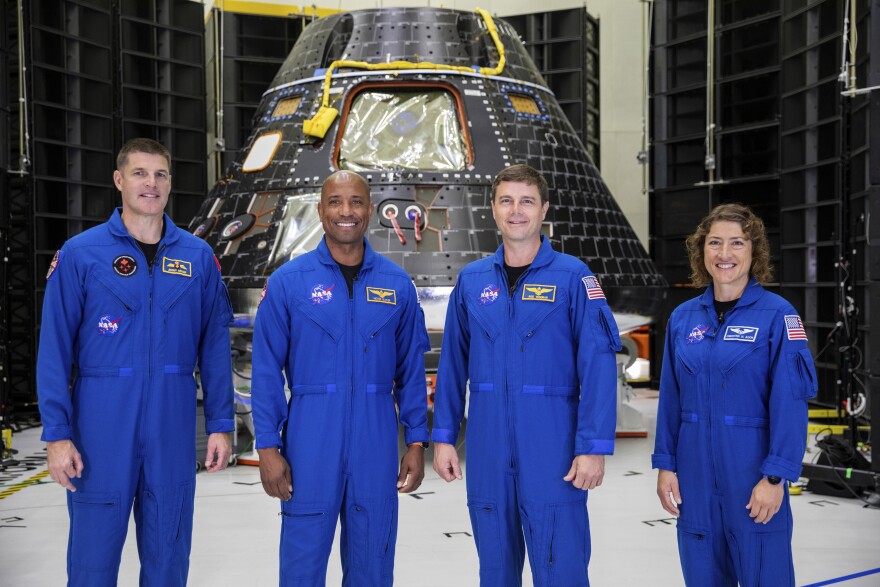 Artemis II crew members, from left, Jeremy Hansen, Victor Glover, Reid Wiseman and Christina Koch, stand together at NASA's Kennedy Space Center in Florida, in front of an Orion crew module on Tuesday, Aug. 8, 2023. 