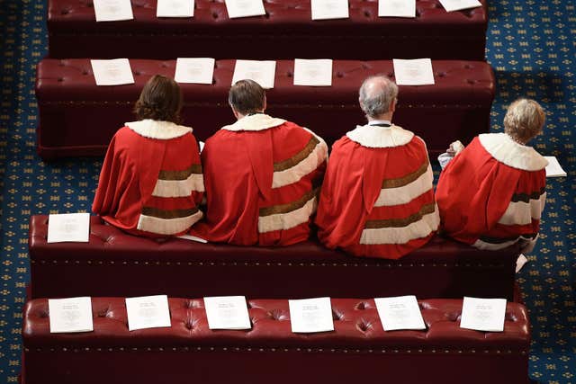 Peers find their places ahead of the State Opening of Parliament by Queen Elizabeth II, in the House of Lords at the Palace of Westminster in London in 2017