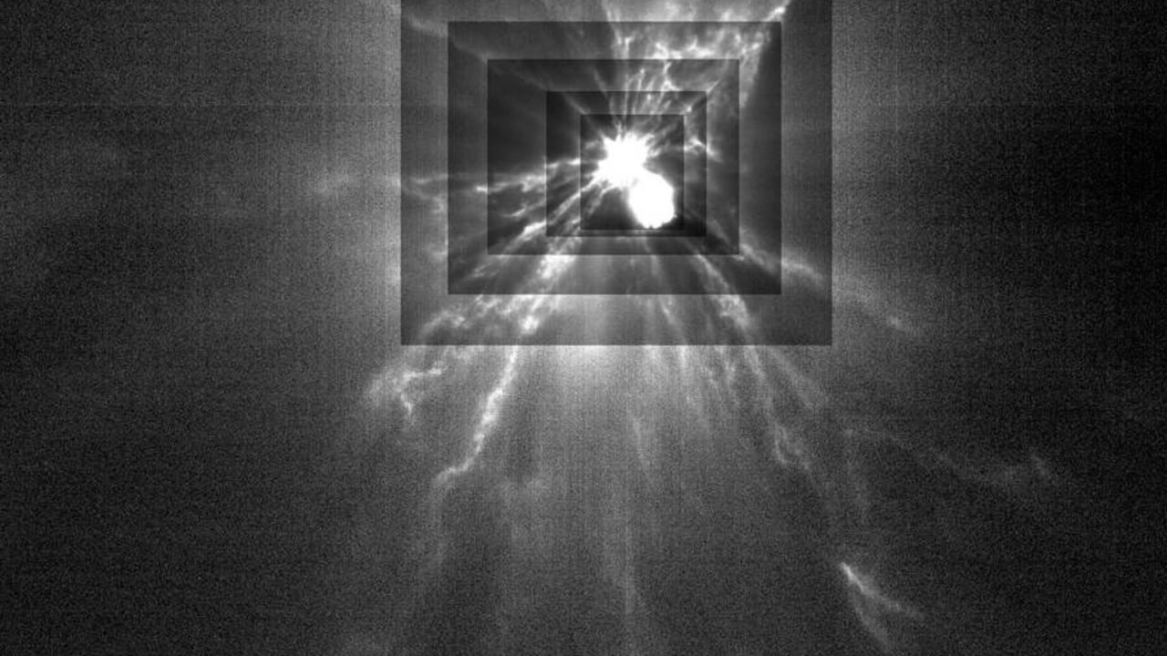 A black and white image shows two small glowing sphere hitting each other with streaks of white lightening-like coming out of the collision 