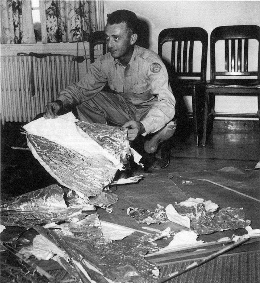 Jesse Marcel, head intelligence officer who investigated and recovered some of the debris from the Roswell UFO site, poses with debris on July 8, 1947.