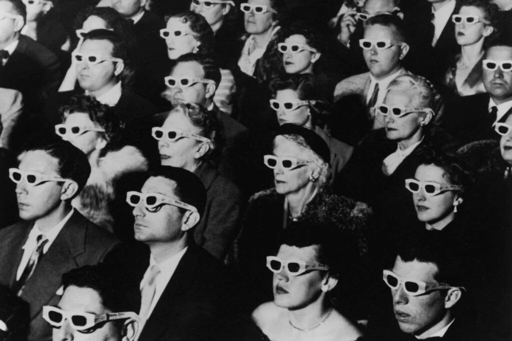 UNITED STATES - NOVEMBER 26: Formally-attired audience sporting 3D glasses during opening night screening of film