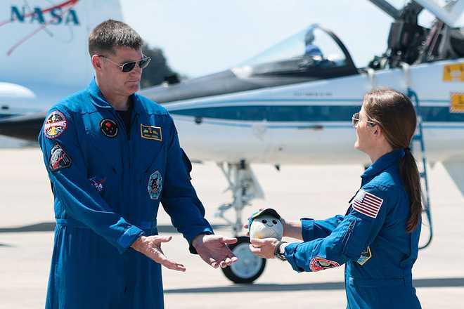 Artemis II Astronauts Arrive At Kennedy Space Center Ahead Of Launch CAPE CANAVERAL, FLORIDA - MARCH 27: Artemis II crew mission specialist Christina Koch (R) hands mission specialist Jeremy Hansen of CSA (Canadian Space Agency) a plush toy of the "moon mascot" after arriving at the Kennedy Space Center on March 27, 2026 in Cape Canaveral, Florida. The astronauts arrived to begin preparations for an April 1, 2026 launch for a 10-day mission, which will take them around the Moon and back to Earth. (Photo by Joe Raedle/Getty Images)
