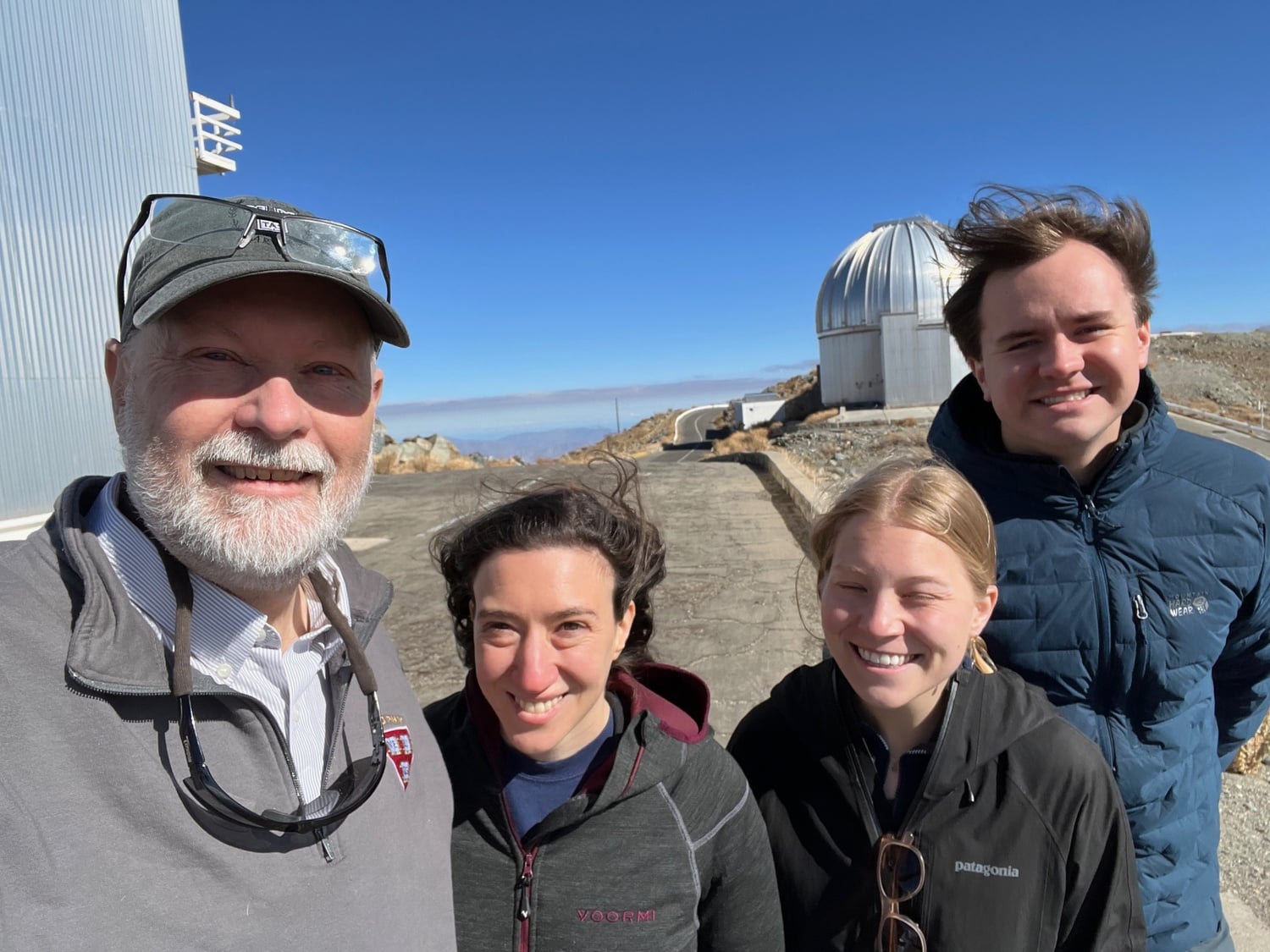 Team members in Chile at the Rubin Observatory. From left to right: Christopher W. Stubbs, research scientist Elana Urbach, Meghan Marangola (who is now in a graduate physics program at Stanford University), and Kane Sjoberg (who is now in a graduate astrophysics program at the California Institute of Technology).