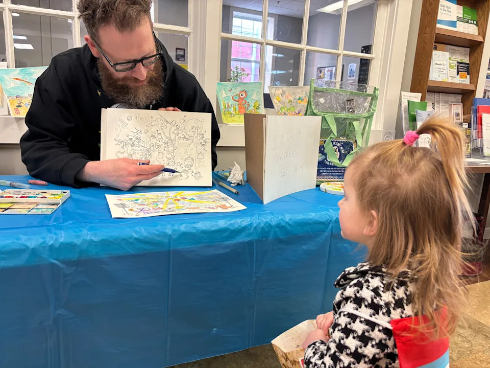 Watercolor artist Seth Holmes talked with Waynesboro Area School District students on March 20, 2026, about the illustrations he created for their stories based on an ‘Alien Takeover’ prompt. The stories were displayed in downtown business windows for a StoryWalk on March 14.