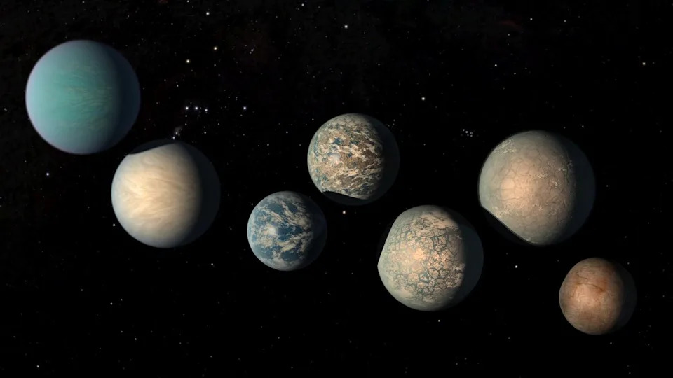  An illustration of a series of brown and blue planets in a dark starry space background. 