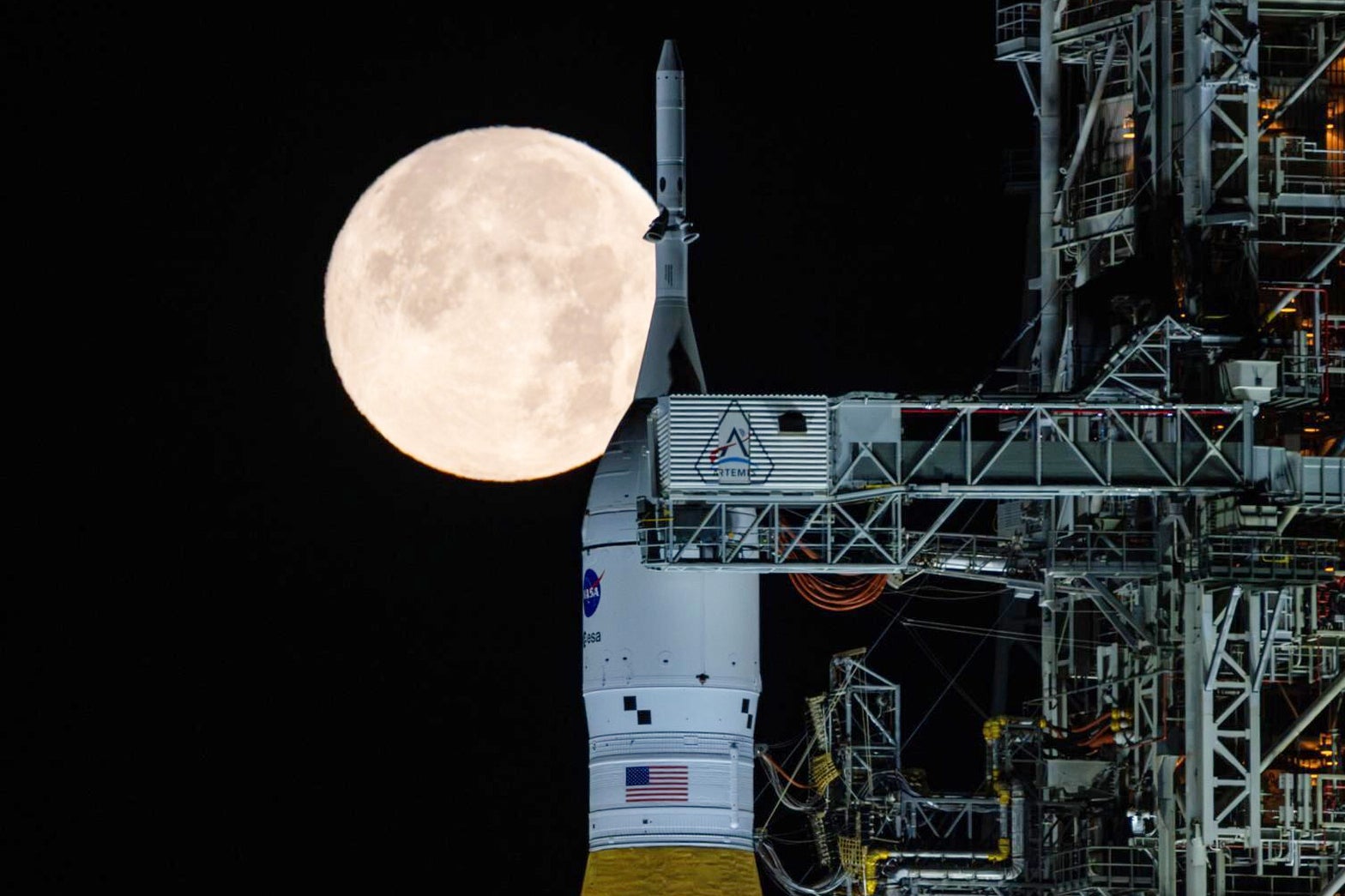 FILE - A full moon is seen shining over NASA's SLS (Space Launch System) and Orion spacecraft, atop the mobile launcher in the early hours of Sunday, Feb. 1, 2026, at NASA's Kennedy Space Center in Florida. (Sam Lott/NASA via AP, File)