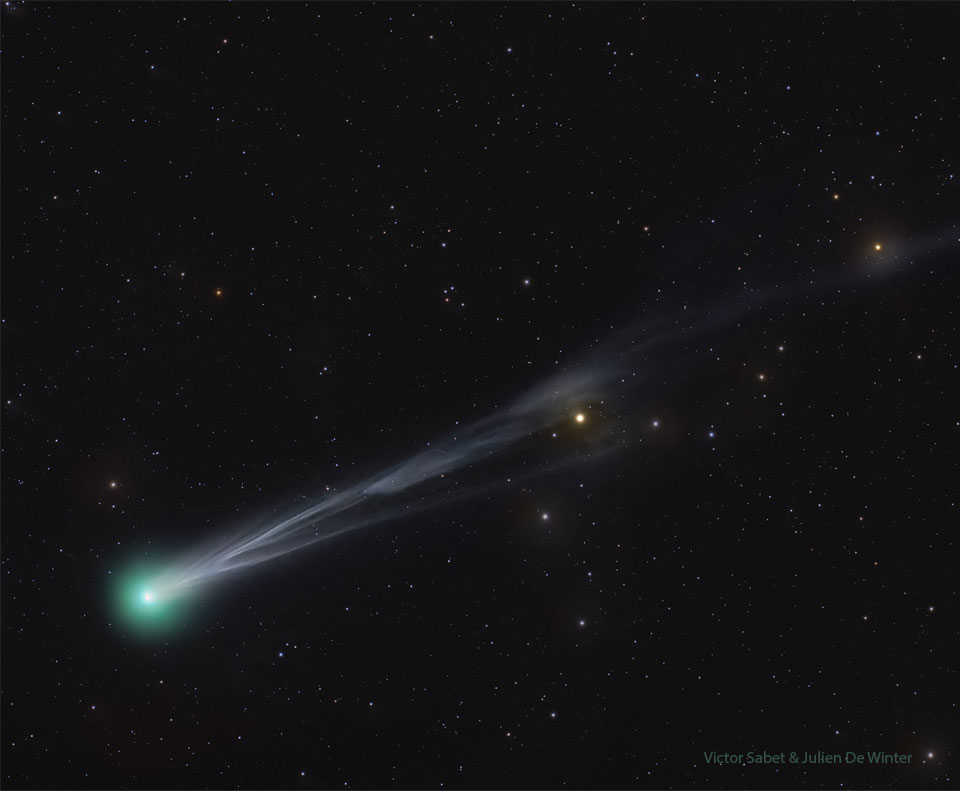 A starfield is shown that has a bright comet.
The comet shows a green head on the lower left and
an ion tail with significant structure extending out
to the upper right.
Please see the explanation for more detailed information.