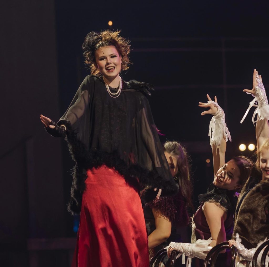 Courtney Hill on stage in costume