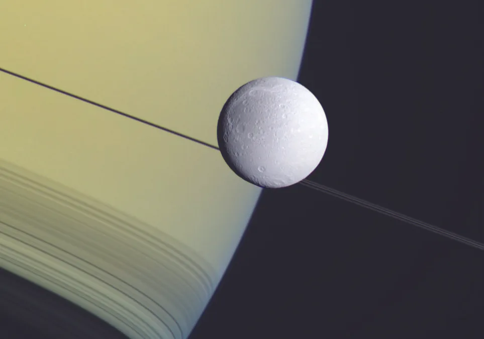 Dione and Saturn in an image captured by the Cassini spacecraft in 2012 and processed by Emily Lakdawalla. Credit: NASA/JPL/SSI/color composite by Emily Lakdawalla