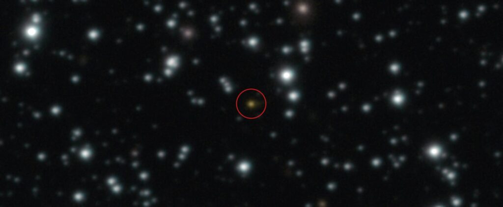 Gamma ray burst circled in red against a background of stars in space