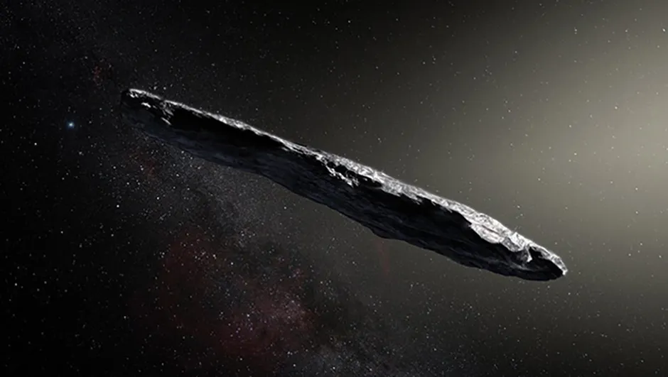 This artist’s impression shows the first interstellar asteroid: `Oumuamua. It could be the strangest of all strangest things in our Solar System