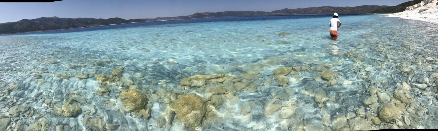 NASA uses this Turkish lake as a Mars analog. The white formations are 3.5-billion-year-old stromatolites — carbonate minerals nearly identical to those found by Perseverance rover in Jezero Crater.
