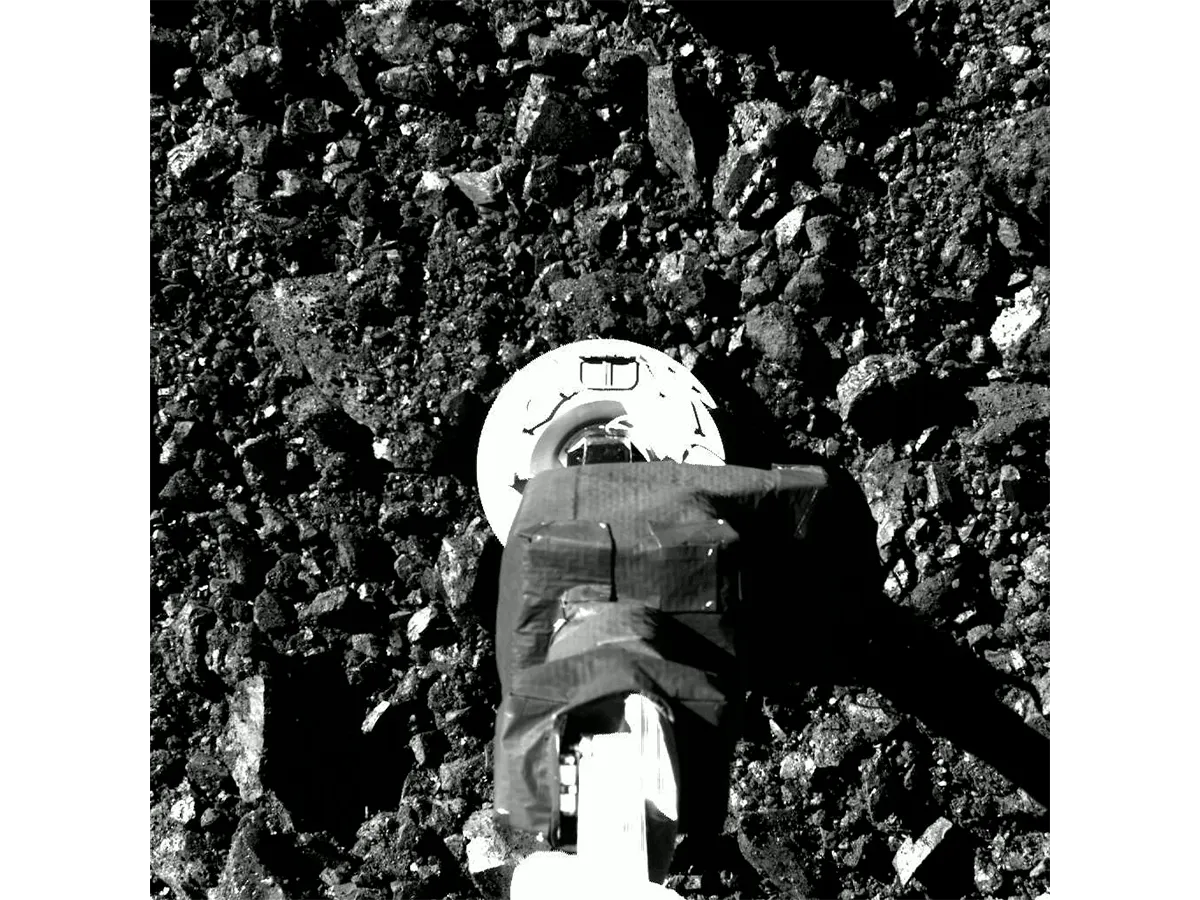 The moment just before the OSIRIS-REx spacecraft touched down on asteroid Bennu's surface, 20 October 2020. OSIRIS-REx was an uncrewed mission that visited an asteroid and returned a sample to Earth. Credit: NASA/Goddard/University of Arizona