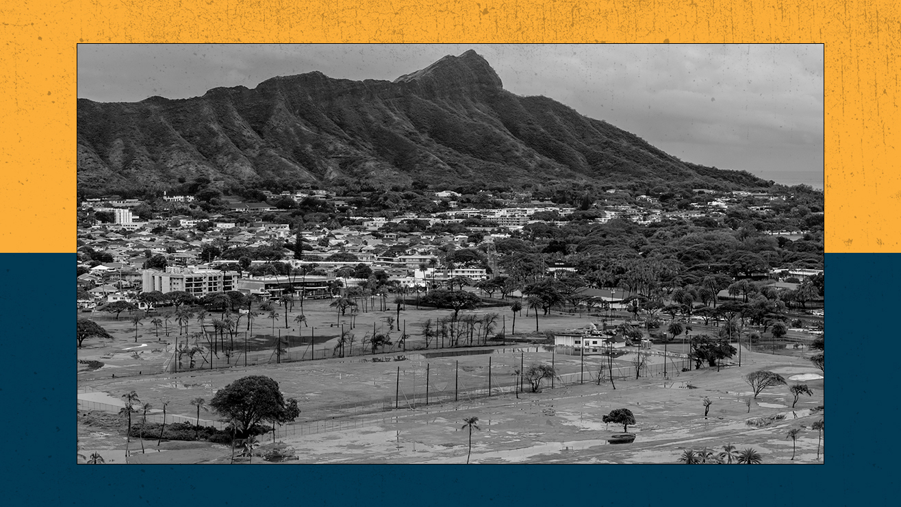 An inundated golf course in the foreground and a mountain in the background.