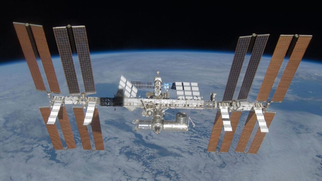 Europe plans EPIC SpaceX mission to send 4 astronauts to the ISS before its retirement a large H-shaped facility consisting of solar panels and metal cylinders floating above a blue and white planet