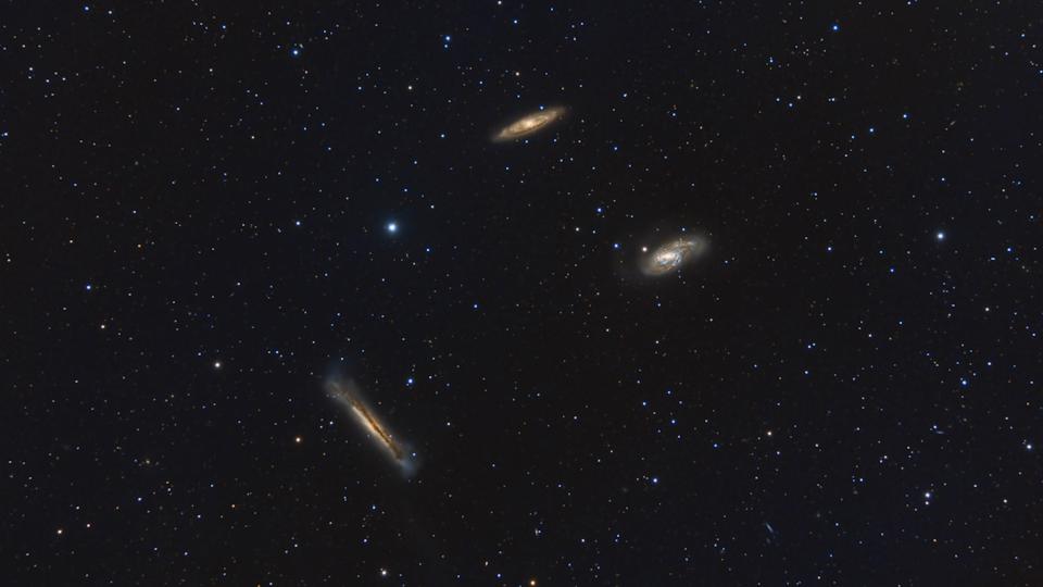Leo Triplet Surrounded By Stars - stock photo The Leo Triplet is a small group of galaxies about 35 million light-years away in the constellation Leo. This galaxy group consists of the spiral galaxies M65, M66, and NGC 3628.
