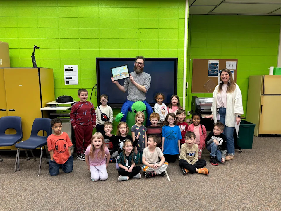 Seth Holmes of Holmes Watercolors illustrated ‘Alien Takeover’ stories written by Waynesboro Area School District students. The stories were displayed in downtown business windows for a StoryWalk on March 14, 2026, and Holmes visited with students and gave them the artwork on March 20.