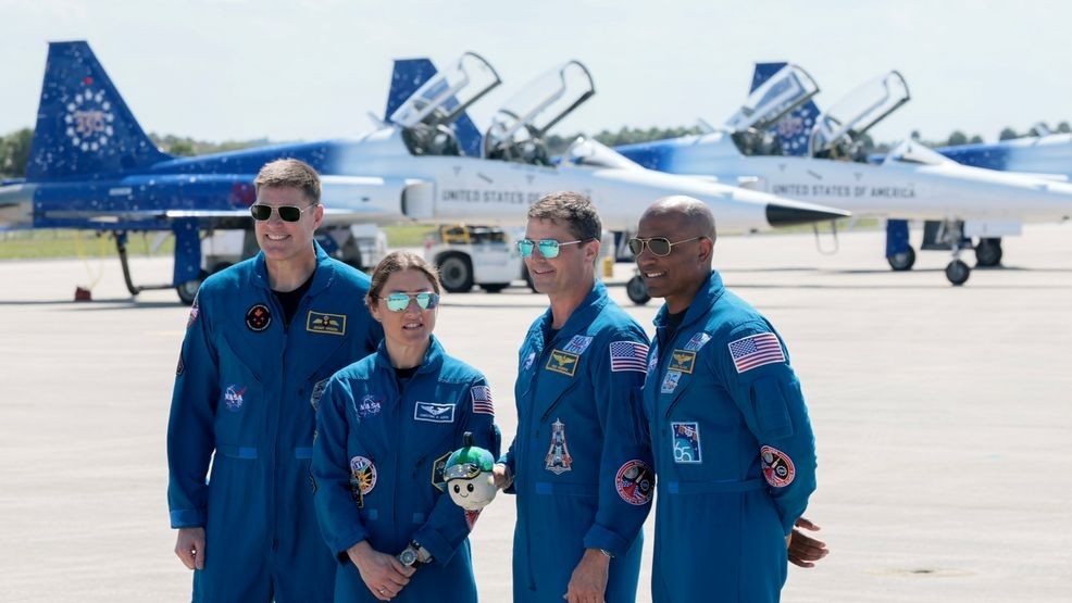 The Artemis II crew – (L-R) mission specialist Jeremy Hansen of CSA (Canadian Space Agency), mission specialist Christina Koch, commander Reid Wiseman and pilot Victor Glover – stand together after arriving at the Kennedy Space Center on March 27, 2026 in Cape Canaveral, Florida. The astronauts arrived to begin preparations for an April 1, 2026 launch for a 10-day mission, which will take them around the Moon and back to Earth. (Photo by Joe Raedle/Getty Images)