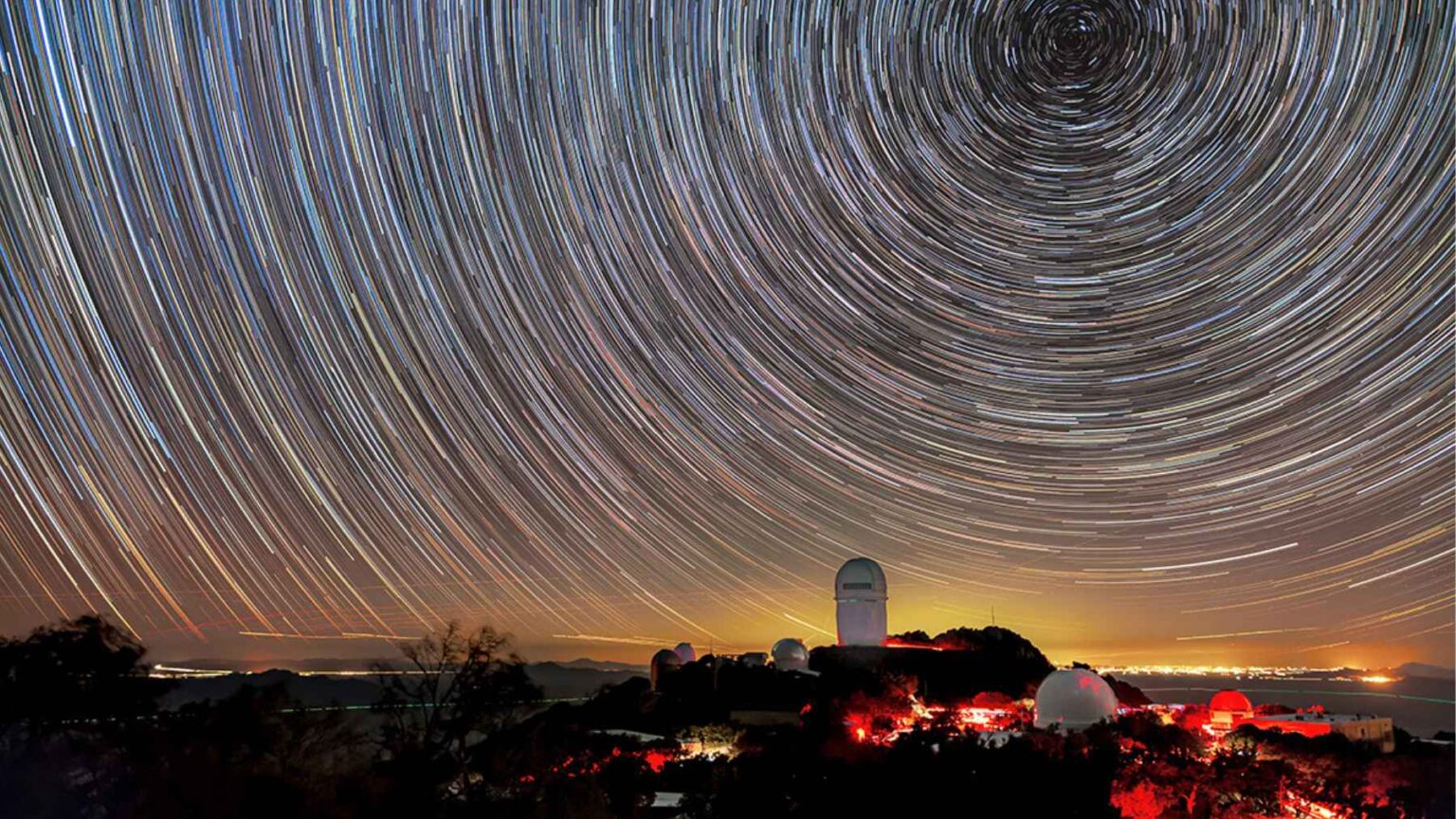 Star trails above an astronomical observatory as scientists revisit the Big Crunch theory and the fate of the universe