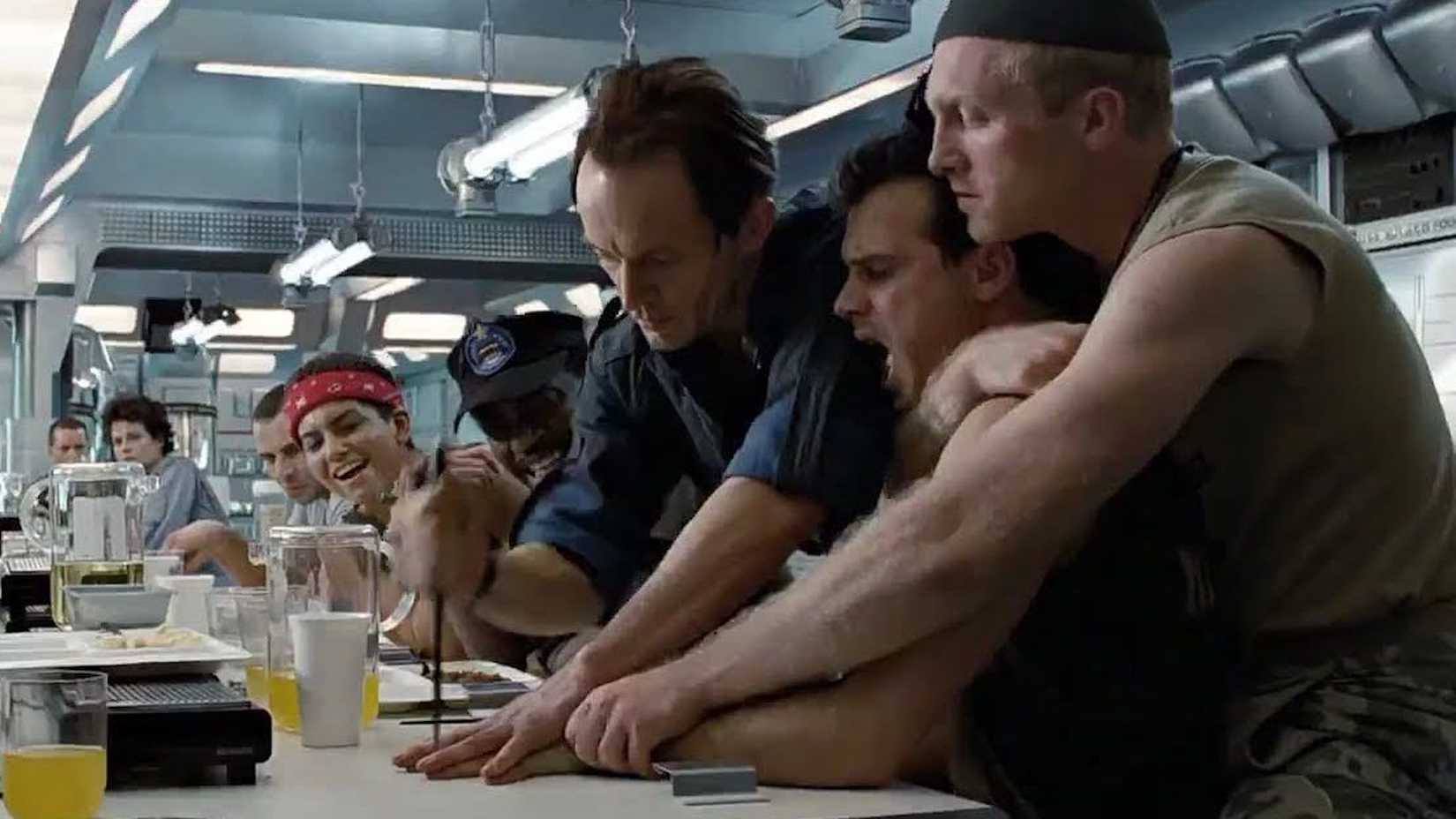 Bishop performing the knife trick at the table in Aliens