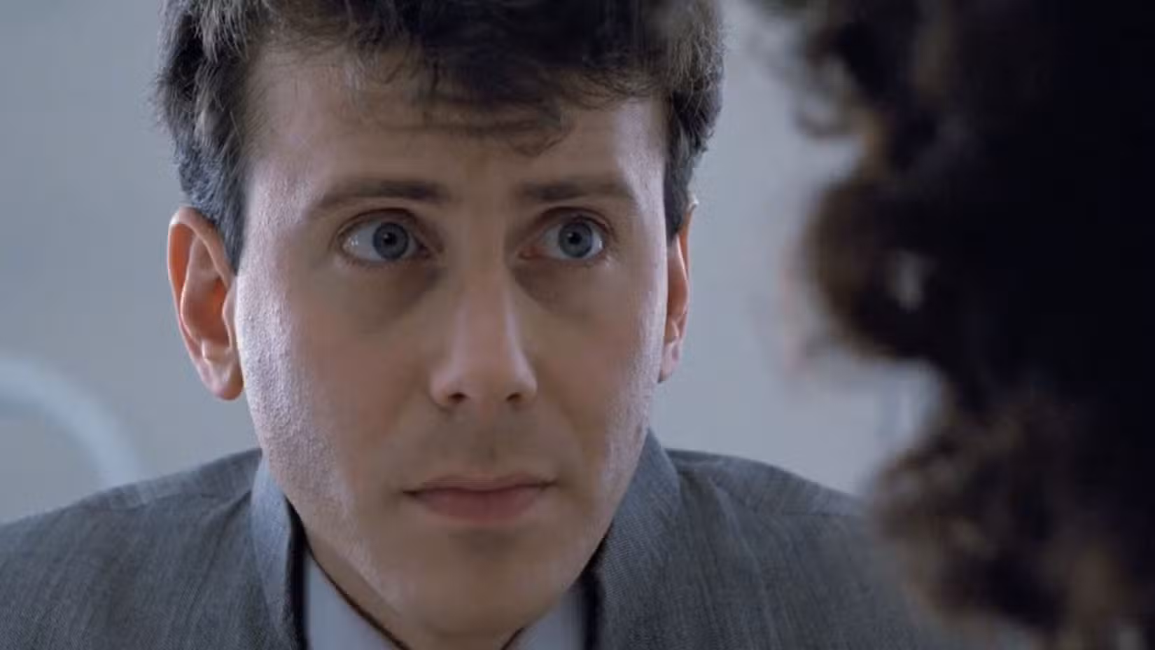 Carter Burke (Paul Reiser) looking concerned talking to Ripley in Aliens