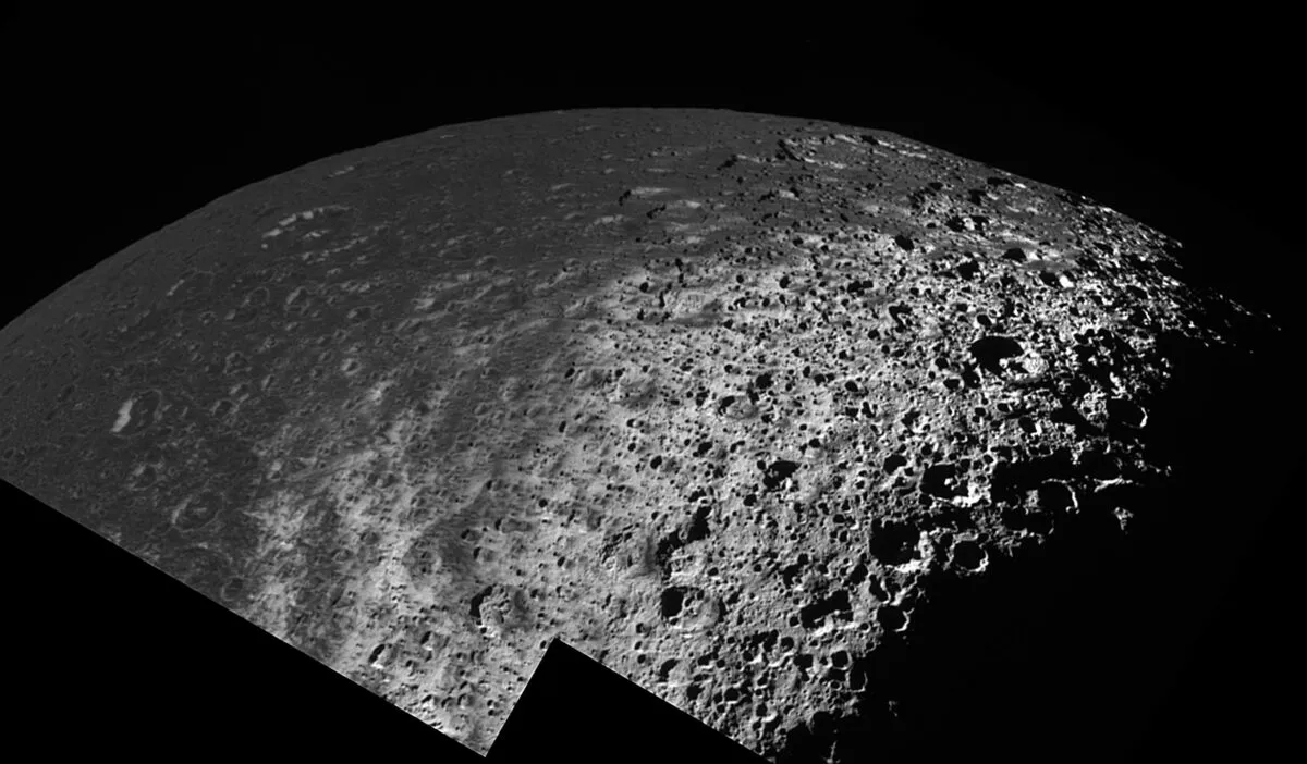 A view of Saturn's moon Iapetus showing the dark, cratered terrain of Cassini Regio transitioning to a bright, icy terrain at high latitudes. Credit: NASA/JPL/Space Science Institute