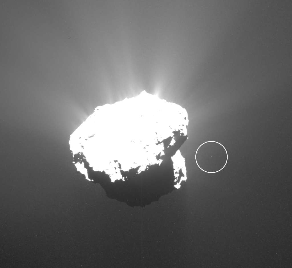 European Space Agency (ESA) Rosetta probe captures a 13-foot/4‑meter "Churyumoon" chunk (circled) orbiting Comet 67P. | October 21ˢᵗ, 2015.