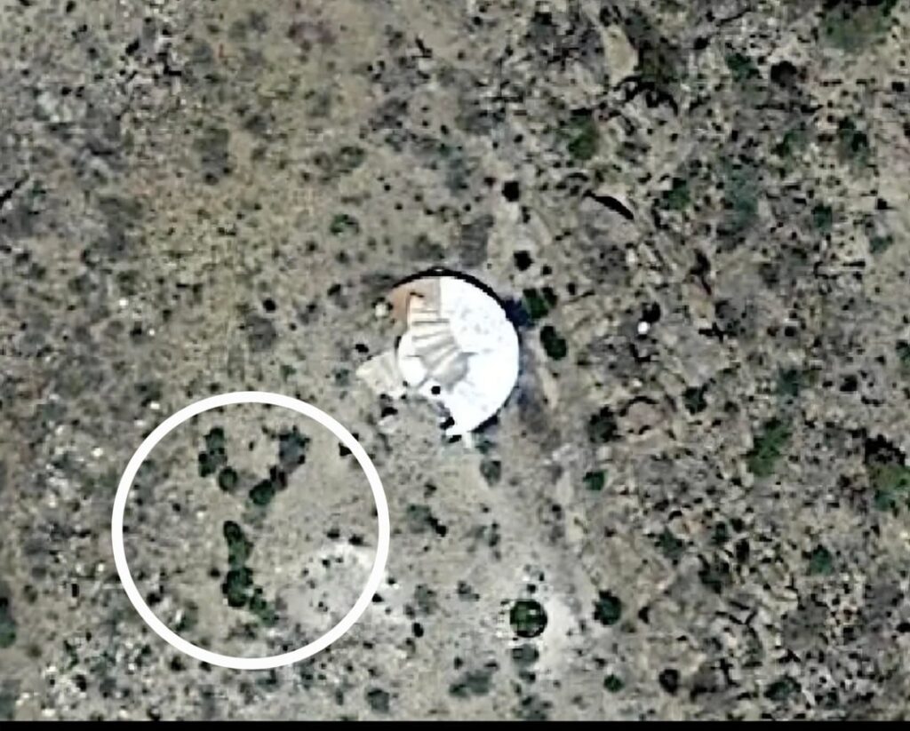 UFO cover-up on Google Earth (actual, physical cover-up or digitally-created "cover"?). NM high desert, lat/long shown. Old satt images show something bright, shiny, white/silver and clearly crash embedded in hillside. See white circles for SAME nearby vegetation pattern! GE now shows buildings...