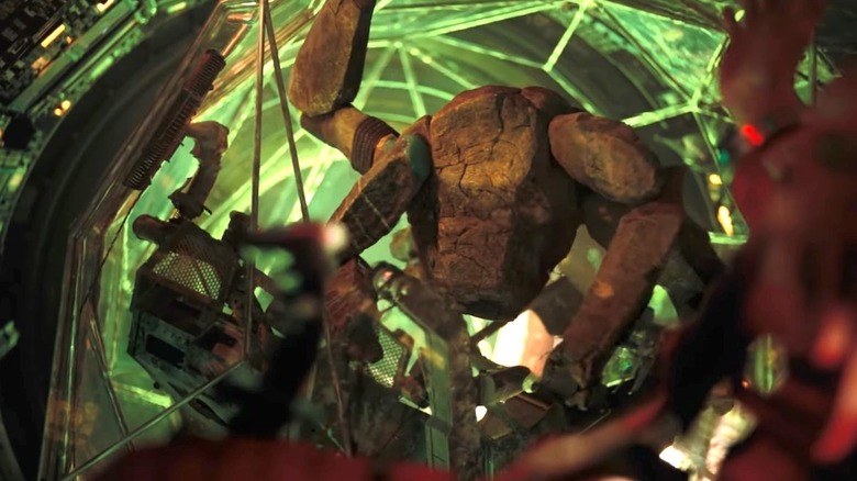 Rocky in his xenonite ball with green light coming from behind him in Project Hail Mary