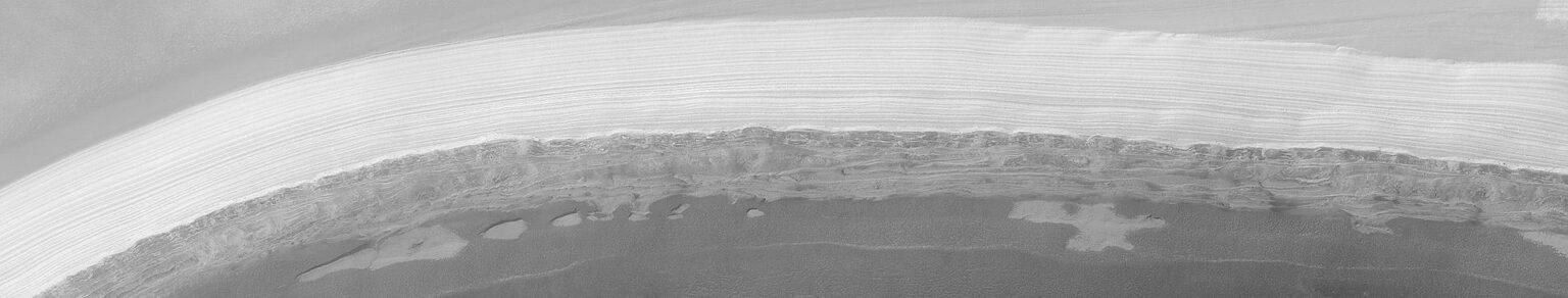 The orbiting Mars Global Surveyor spacecraft was able to get a good glimpse of the water-bearing cap just before Martian spring. Low, dark layers in the above image are thought to contain a large amount of sand, while high, light layers likely contain higher amounts of water-ice.  (MSSS, JPL, NASA)