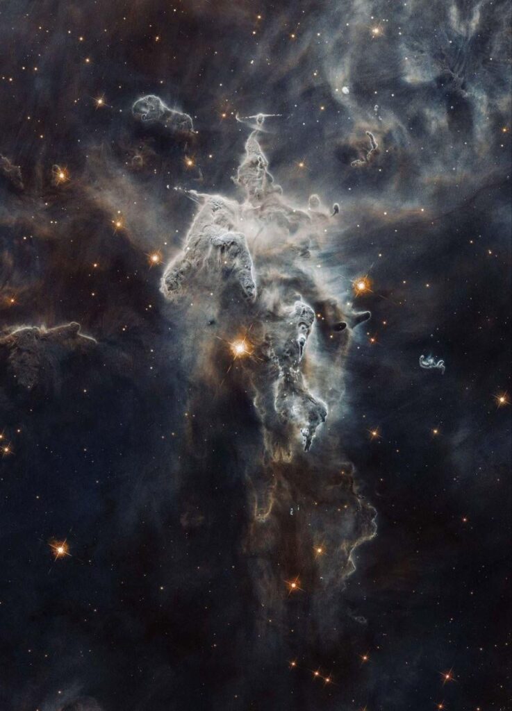 This is one of the best space images ever. You are staring at the Carina Nebula.This entire structure is three light-years tall. 7,500 light-years away from us.