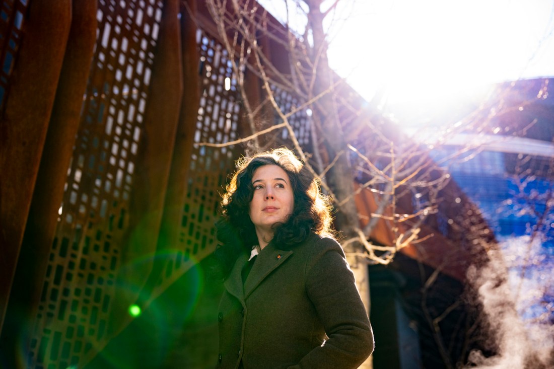 Anncy Thresher stands in front of a rust iron wall on Northeastern's Boston campus.
