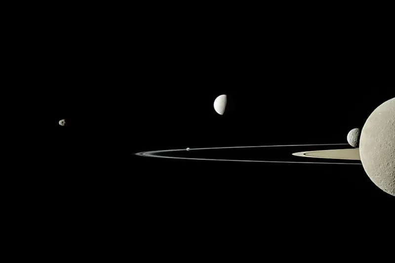 Saturn is king of the moons because it's the planet in our Solar System with the most moons. This Cassini image shows Saturn's rings and its moons Pandora, Enceladus, Rhea and Mimas. Credit: NASA/JPL-Caltech/Space Science Institute