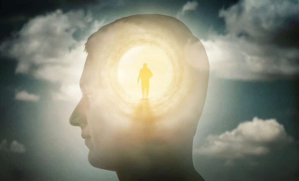 Quantum Physics Says You Never Actually Die, Your Consciousness Just Jumps to a Parallel Universe Silhouette Of A Man With Rays Of Light Emanating From His Brain As A Symbol Of The Power Of Thought
