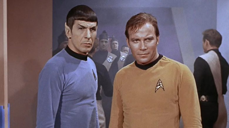 Spock with a straight face and Kirk smiling in 