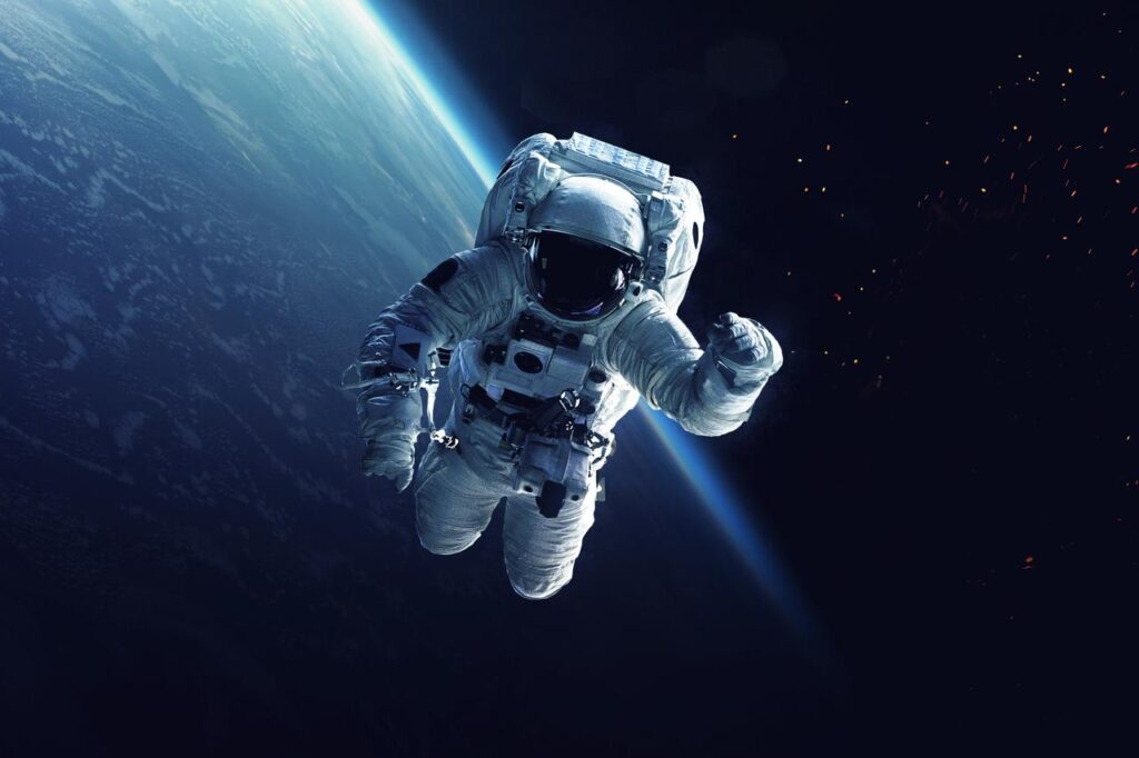 An astronaut floats in space above Earth during a spacewalk. (Adobe Stock Photo)