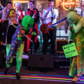 people dressed as aliens dancing in front of a band